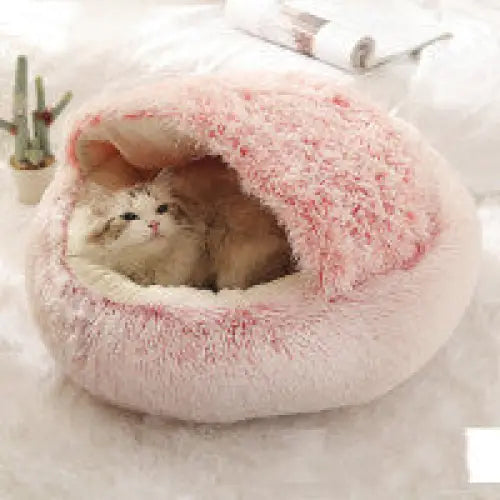 Soft plush round pet bed providing cozy warmth for cats and dogs.