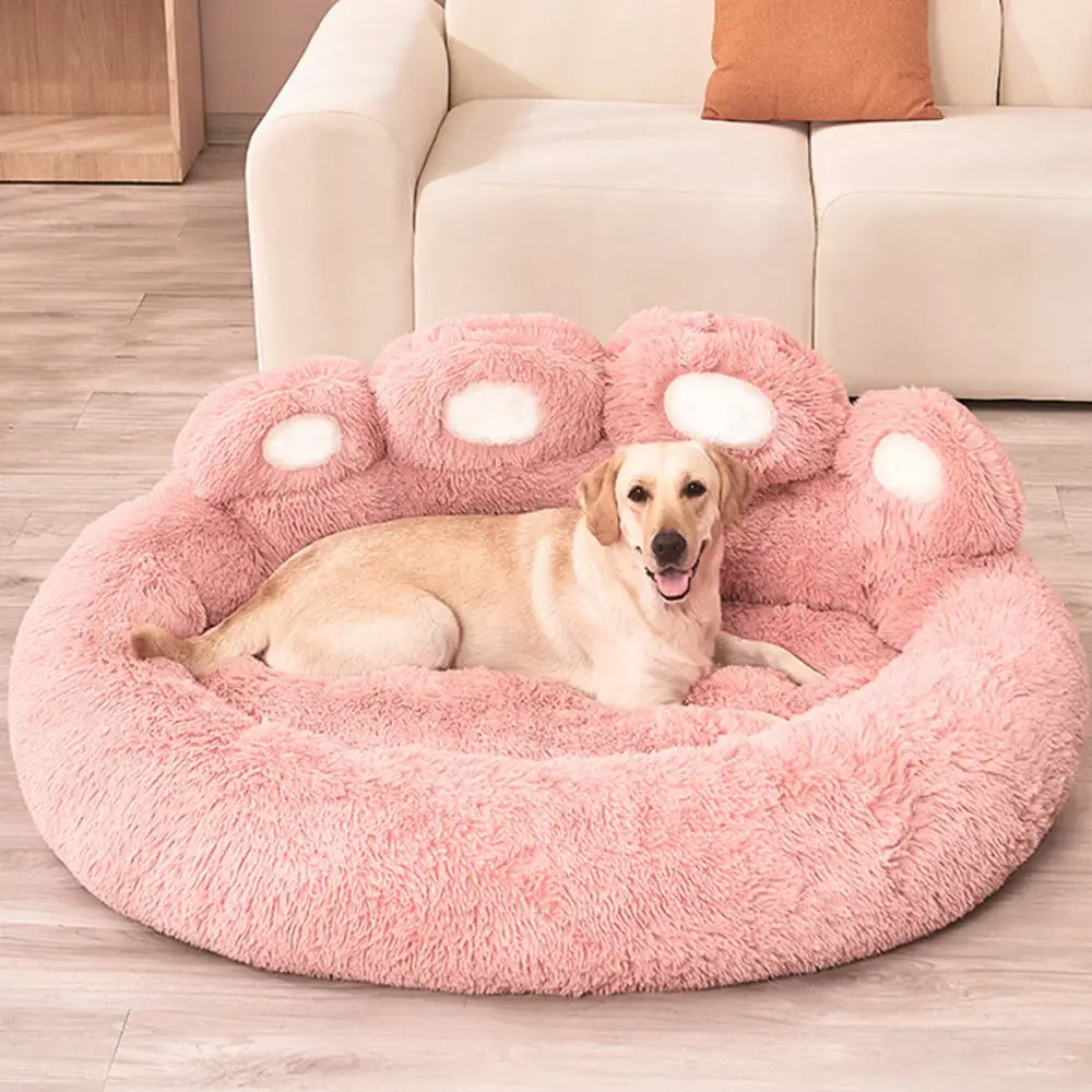 Cozy pink sofa bed for dogs with a plush paw design, perfect for small to medium breeds.