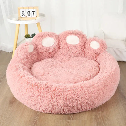 Cozy pink plush sofa bed for dogs with paw design, ideal for small pets.